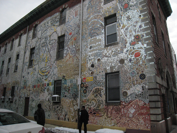 A three story mirrored mosaic on an alley off South Street in Philadelphia by Isaiah Zagar.